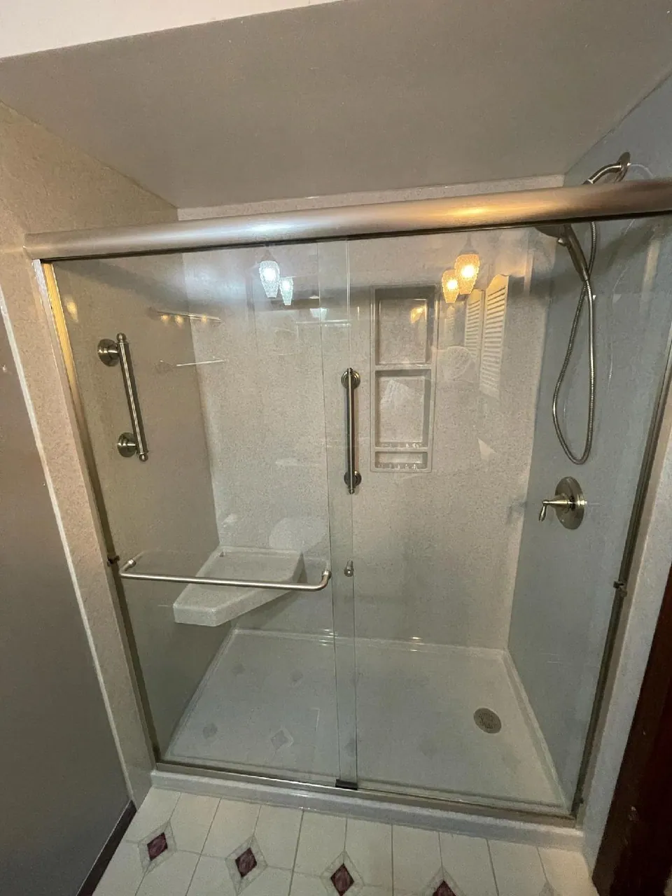 Accessible walk-in shower with a built-in bench, grab bar, and low-threshold base — an Excel install in the south suburbs