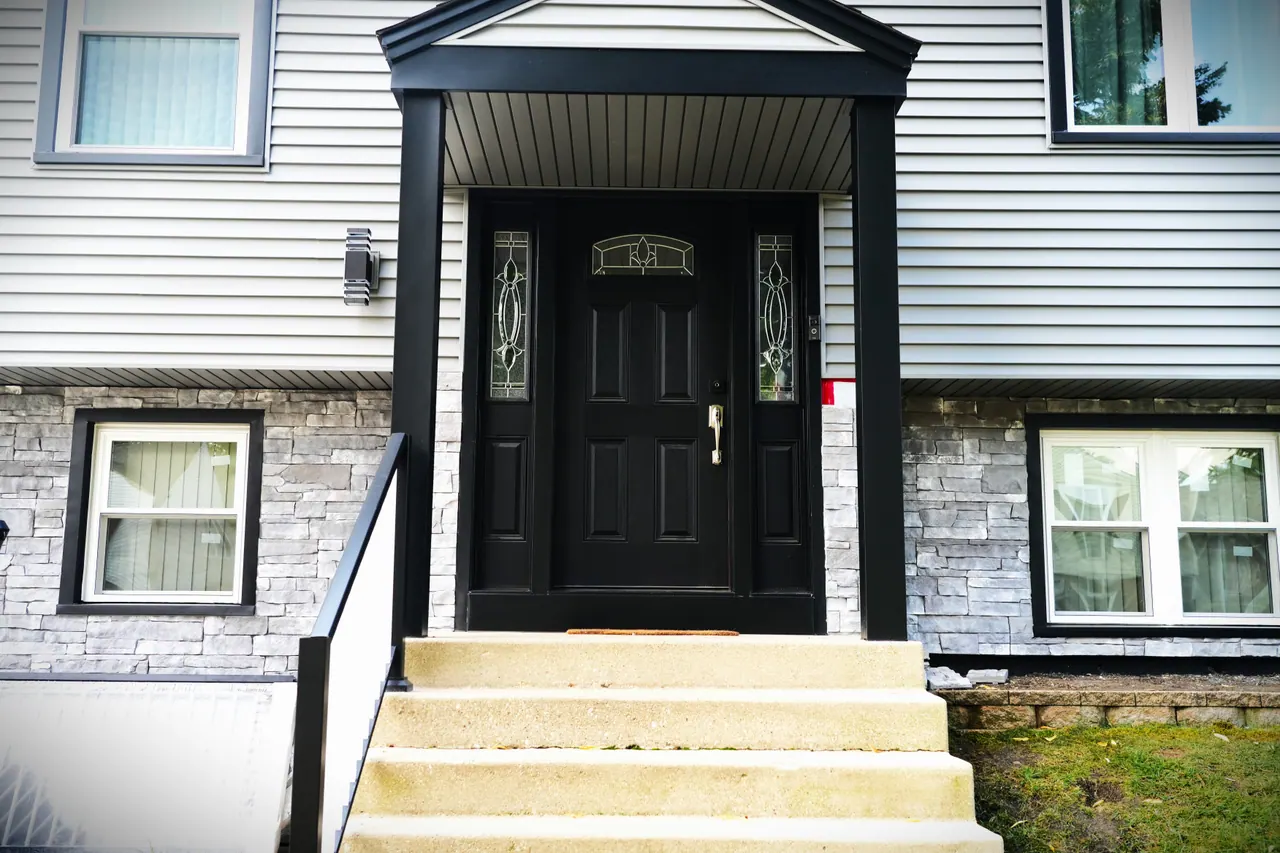 New fiberglass entry door with decorative-glass sidelites on a south-suburb home