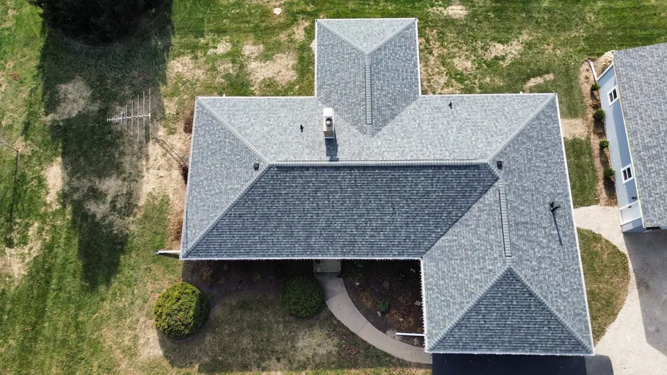 An aerial overhead view of a finished asphalt-shingle roof on a Chicagoland south-suburb home