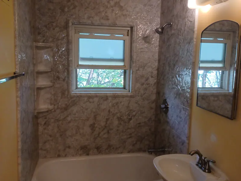 Finished walk-in shower with a solid-surface surround and a built-in bench, an Excel install in the south suburbs